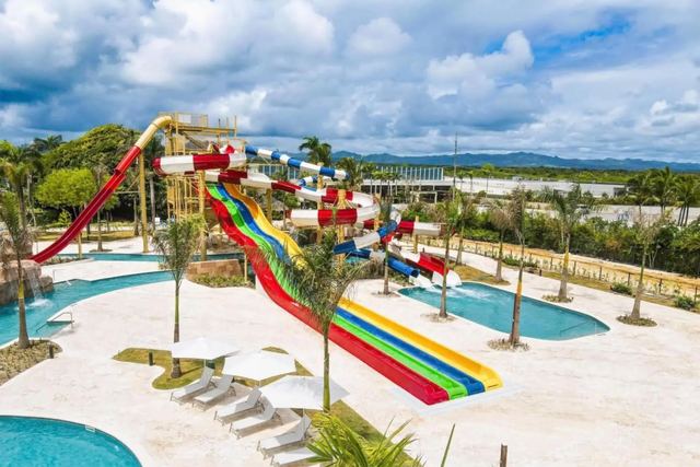 Tall rainbow waterslides and splash pools at the waterpark