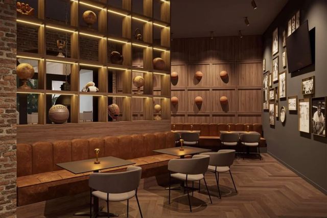Lounge bar with leather banquettes and shelving lit with warm accents